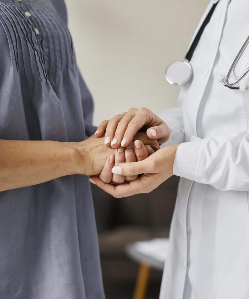 covid-recovery-center-female-doctor-holding-older-patient-s-hands covid-recovery-center-female-doctor-holding-older-patient-s-hands