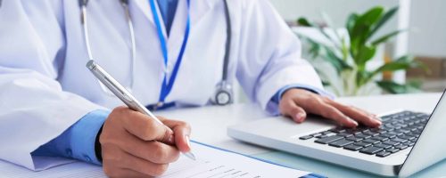 Filling document Doctor checking information in computer program before filling medical card