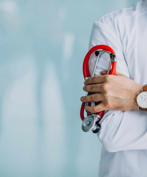 Young handsome physician in a medical robe with stethoscope Young handsome physician in a medical robe with stethoscope